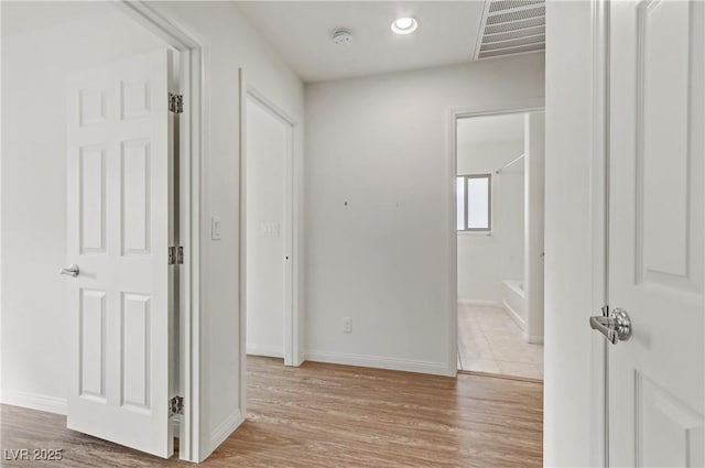 hall with light hardwood / wood-style floors