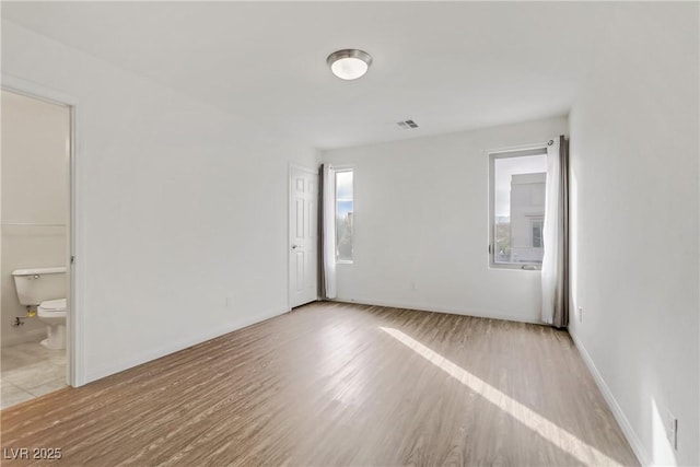 spare room featuring light wood-type flooring