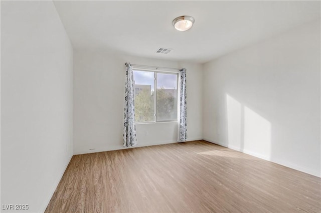 spare room with light wood-type flooring