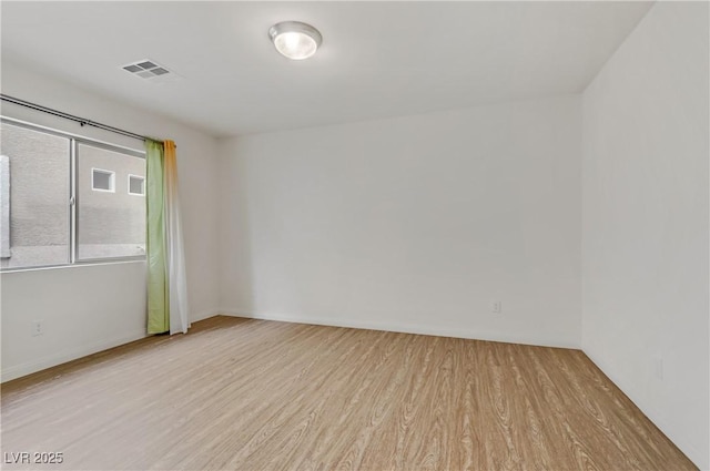 unfurnished room with light hardwood / wood-style floors