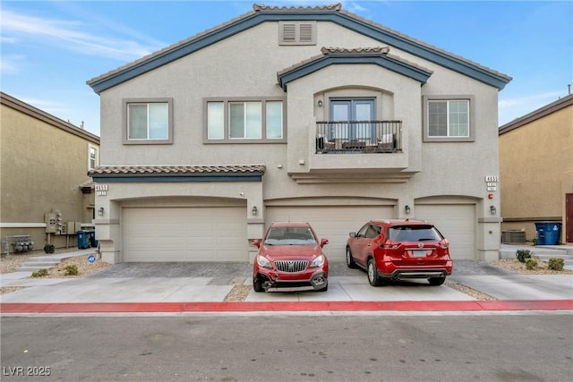 view of front of house with a garage and central AC