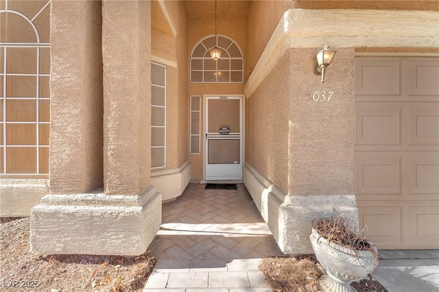 doorway to property with a garage