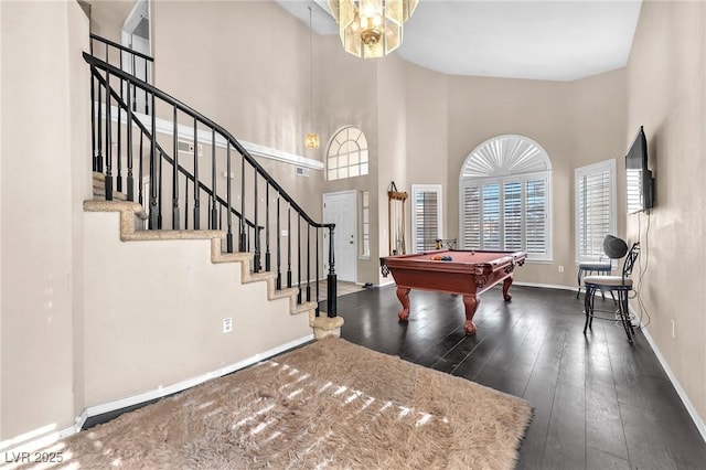 playroom with dark hardwood / wood-style flooring, billiards, and a high ceiling