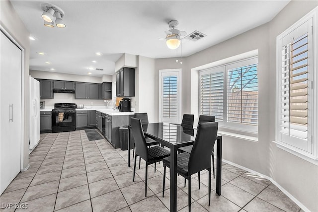 dining area featuring ceiling fan and light tile patterned floors