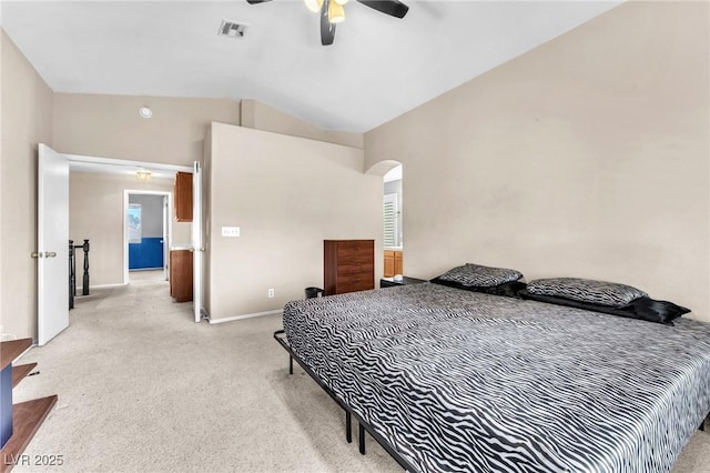 bedroom featuring ceiling fan, lofted ceiling, and light carpet