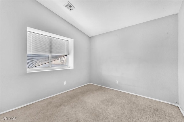 spare room with lofted ceiling and carpet floors