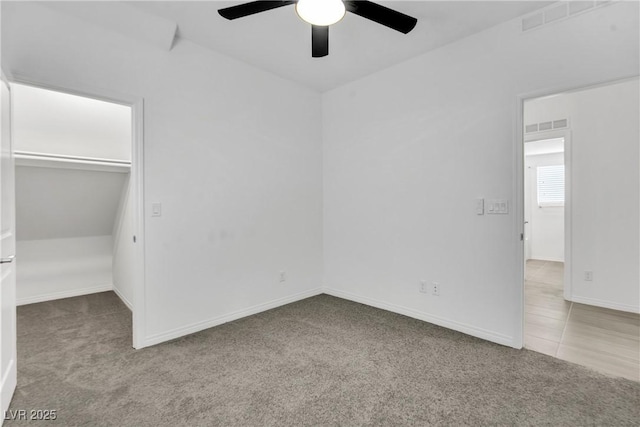 unfurnished bedroom featuring light carpet, a closet, and ceiling fan