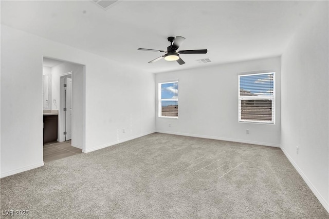 carpeted empty room featuring ceiling fan