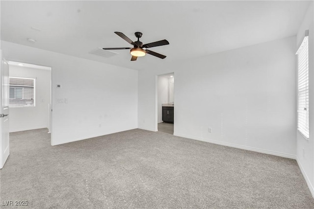 unfurnished living room featuring ceiling fan and light carpet