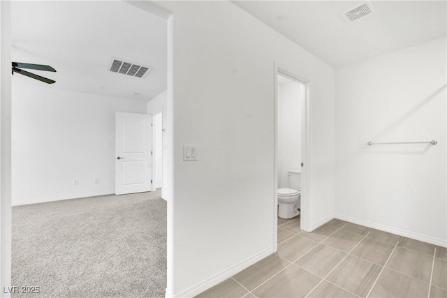 bathroom with ceiling fan and toilet