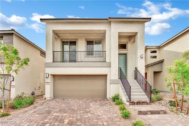 view of front of property featuring a balcony and a garage