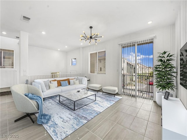 living room featuring a notable chandelier and light tile patterned flooring