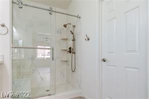 bathroom with a shower with door