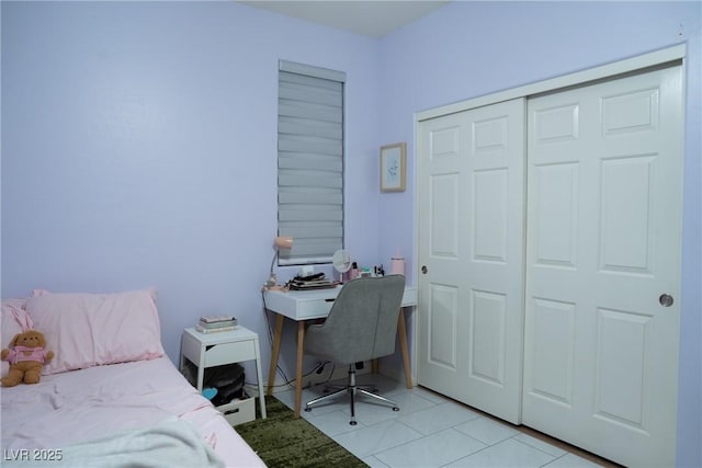 tiled bedroom with a closet