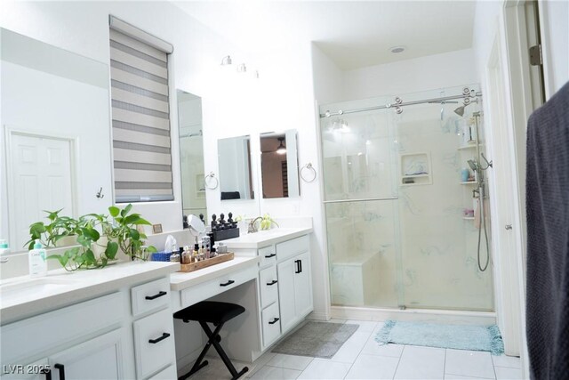 bathroom with tile patterned floors, vanity, and an enclosed shower