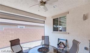 view of patio with ceiling fan and an outdoor fire pit