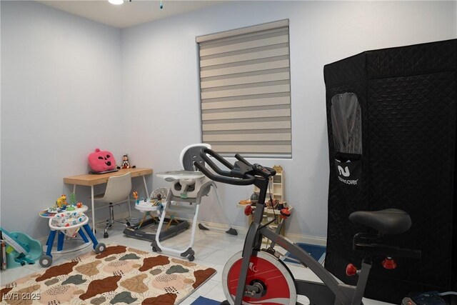 workout area featuring light tile patterned floors