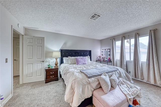 carpeted bedroom with a textured ceiling