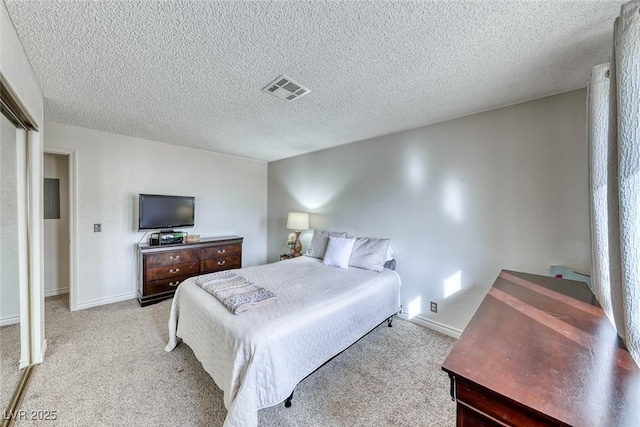 carpeted bedroom with a textured ceiling