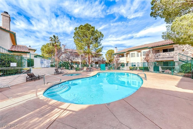 view of pool featuring a hot tub and a patio area