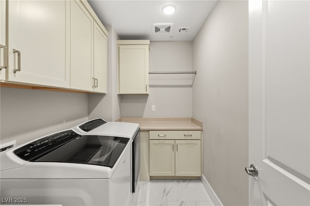 laundry area with cabinets and washing machine and dryer