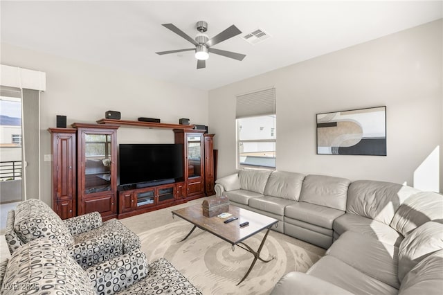 living room with light colored carpet and ceiling fan