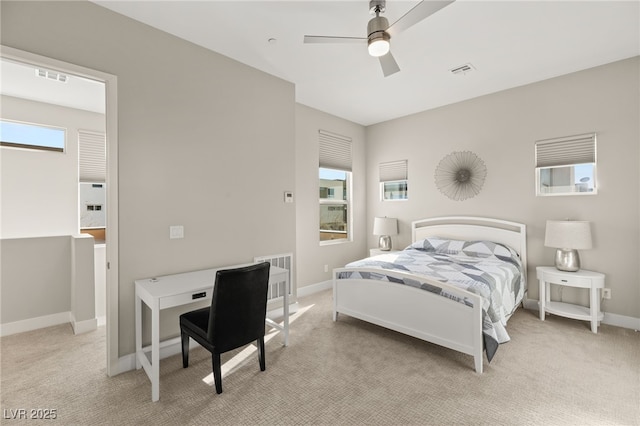 carpeted bedroom with multiple windows and ceiling fan