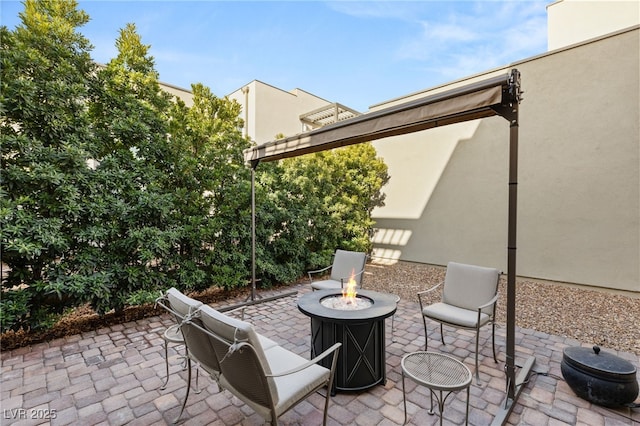 view of patio / terrace featuring an outdoor fire pit