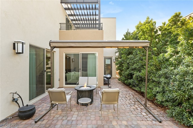 view of patio with area for grilling and an outdoor fire pit