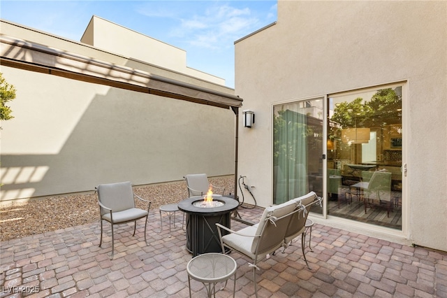 view of patio / terrace featuring an outdoor fire pit