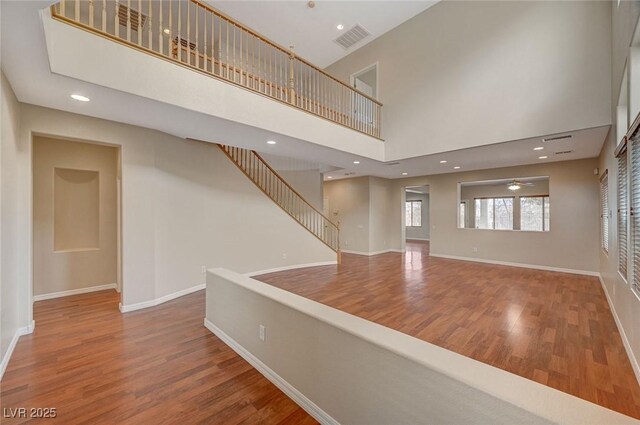 hallway featuring a high ceiling and hardwood / wood-style flooring