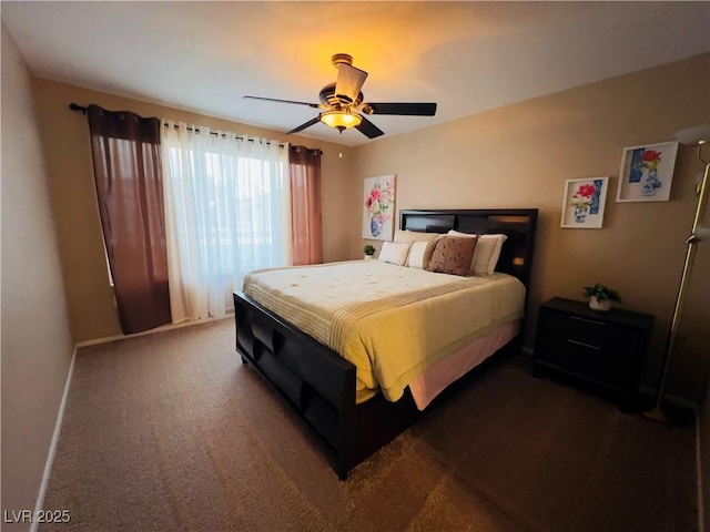 bedroom with dark colored carpet, baseboards, and a ceiling fan