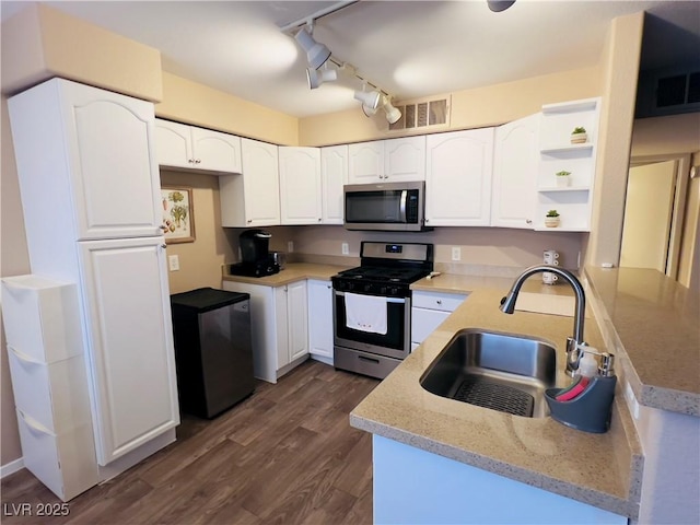 kitchen featuring a sink, visible vents, open shelves, and appliances with stainless steel finishes