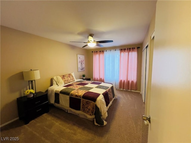 bedroom featuring dark colored carpet, a closet, and ceiling fan