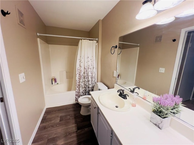 full bathroom with visible vents, toilet, wood finished floors, shower / tub combo, and vanity