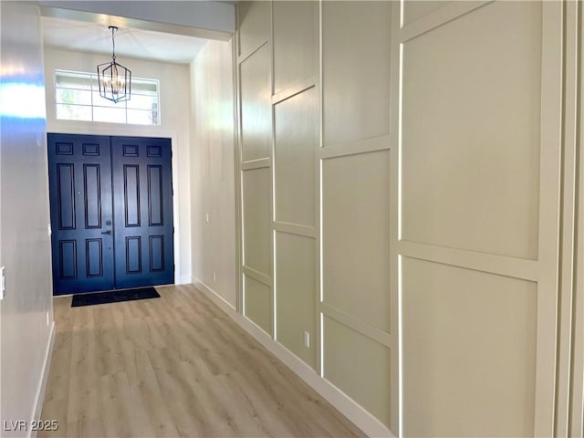 entrance foyer featuring a chandelier and light wood-type flooring