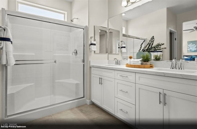 bathroom featuring tile patterned flooring, vanity, a shower with shower door, and ceiling fan