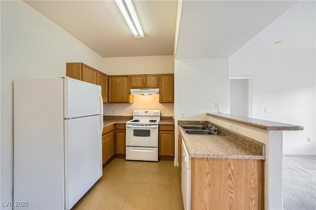 kitchen featuring a breakfast bar, sink, white appliances, kitchen peninsula, and light colored carpet