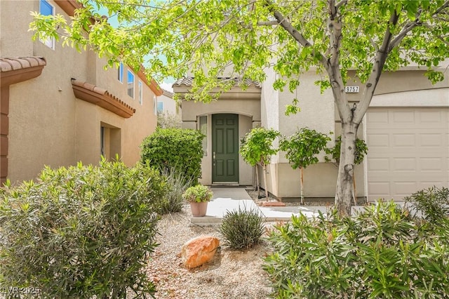 doorway to property with a garage