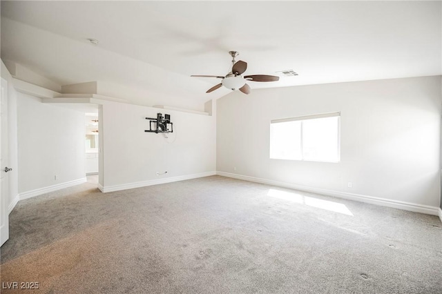 unfurnished room with vaulted ceiling, carpet, a healthy amount of sunlight, and ceiling fan