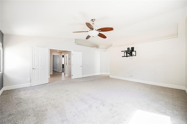 carpeted empty room with vaulted ceiling and ceiling fan