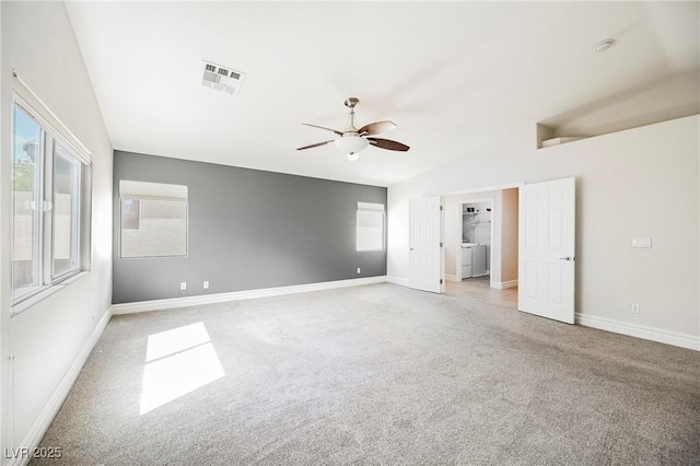 empty room with lofted ceiling, light carpet, plenty of natural light, and ceiling fan