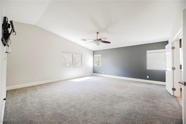 carpeted spare room featuring lofted ceiling and ceiling fan