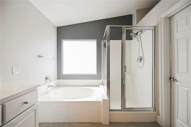 bathroom featuring lofted ceiling, vanity, and plus walk in shower