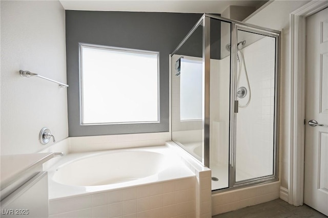 bathroom featuring separate shower and tub