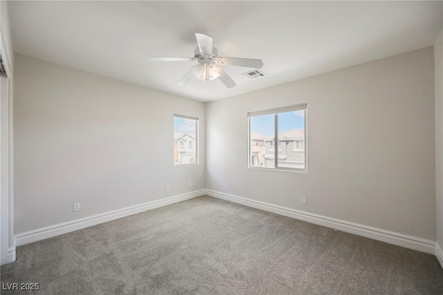 carpeted spare room with ceiling fan