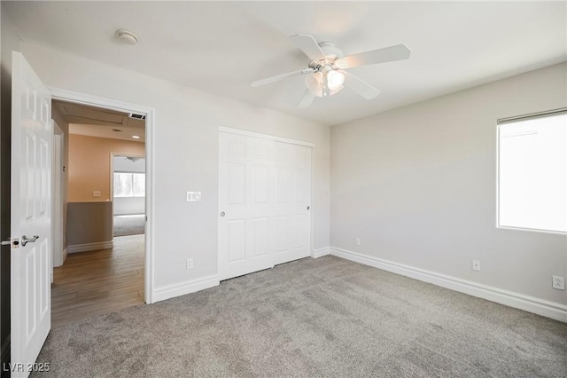 unfurnished bedroom featuring carpet flooring, ceiling fan, and a closet