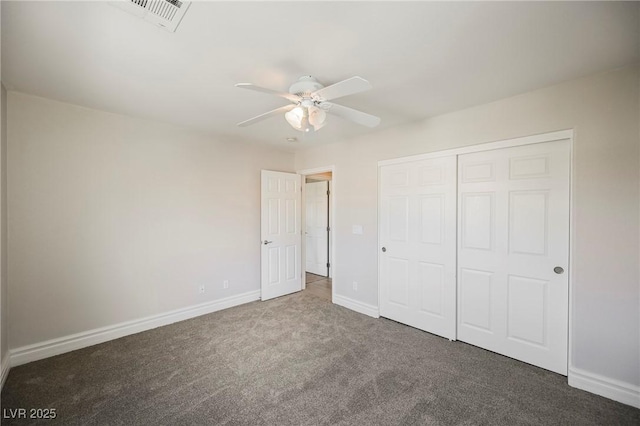 unfurnished bedroom with ceiling fan, a closet, and dark colored carpet