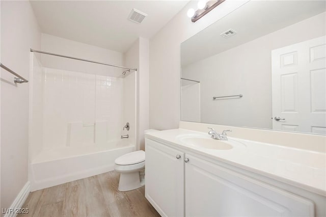 full bathroom featuring hardwood / wood-style flooring, bathing tub / shower combination, vanity, and toilet