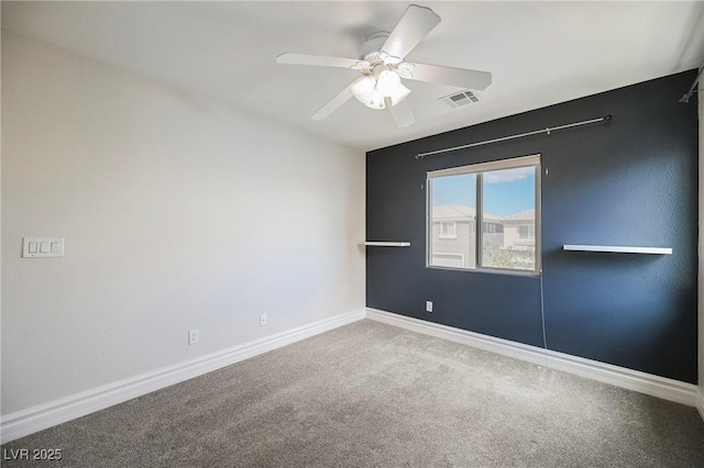 empty room with ceiling fan and carpet